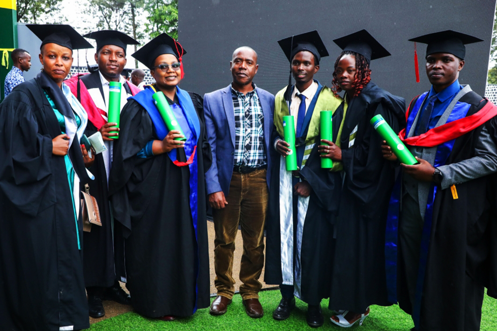 Damien Hanyurwimfura, an Associate Professor and the Acting Director of the African Center of Excellence in Internet of Things (ACEIoT), College of Science and Technology (CST), UR pose for a photo with his students